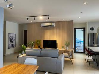 Spacious master bedroom with king bed and ensuite bathroom at River Valley Panama Pacifico apartment