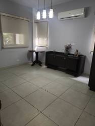 Modern kitchen with granite counters, cabinets and appliances in duplex house at Panama Pacifico