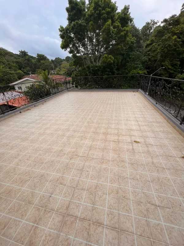 Large attic loft area with tile floors, ceiling fans, arched windows, Altos de Curundu house Panama