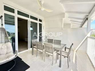 Covered balcony with dining table and hanging chair Marina Village Buenaventura Panama