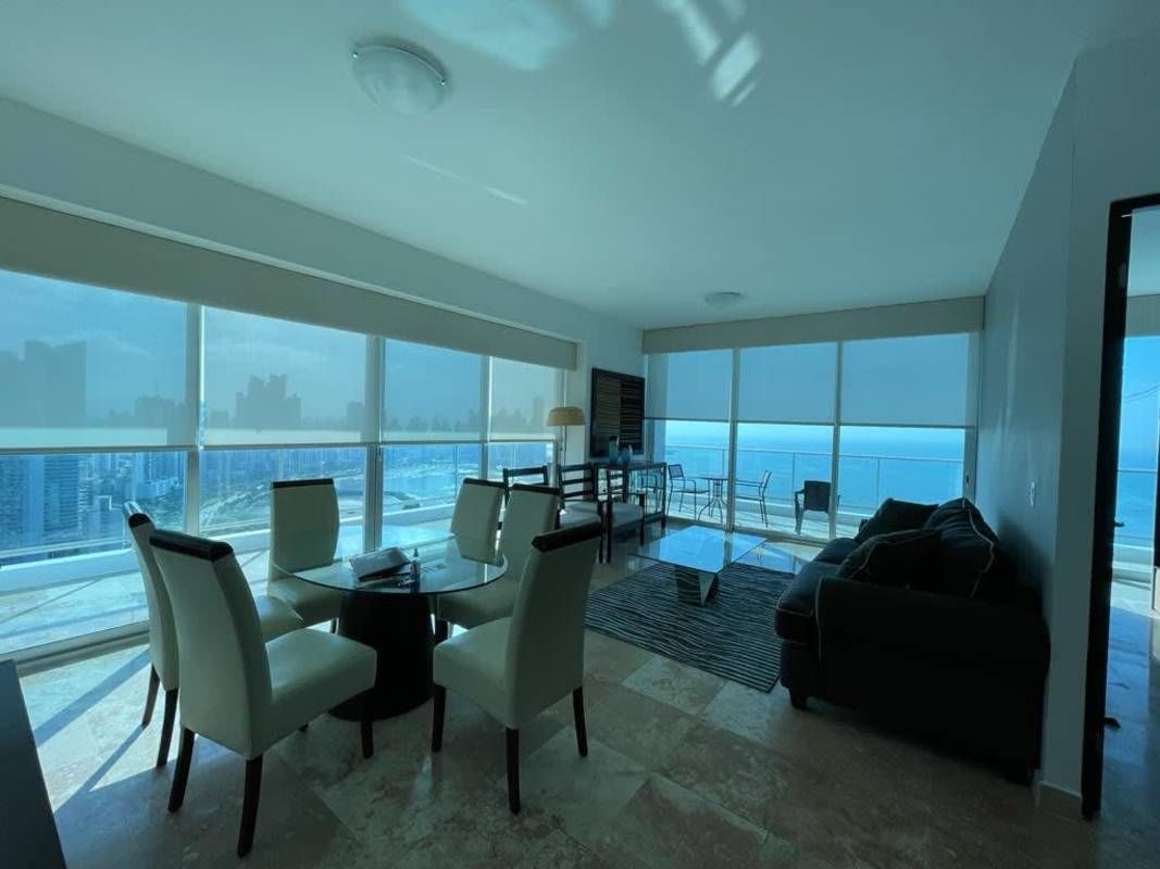 Modern furnished living room with panoramic ocean views floor-to-ceiling windows and balcony PH BICSA Panama