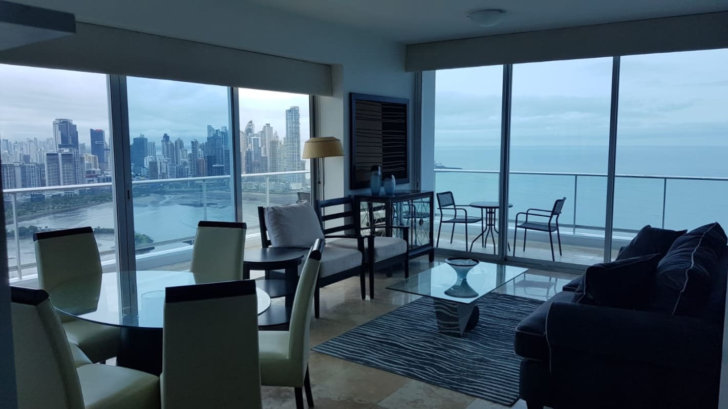 Dining area with glass table ocean views in PH BICSA apartment Avenida Balboa Panama