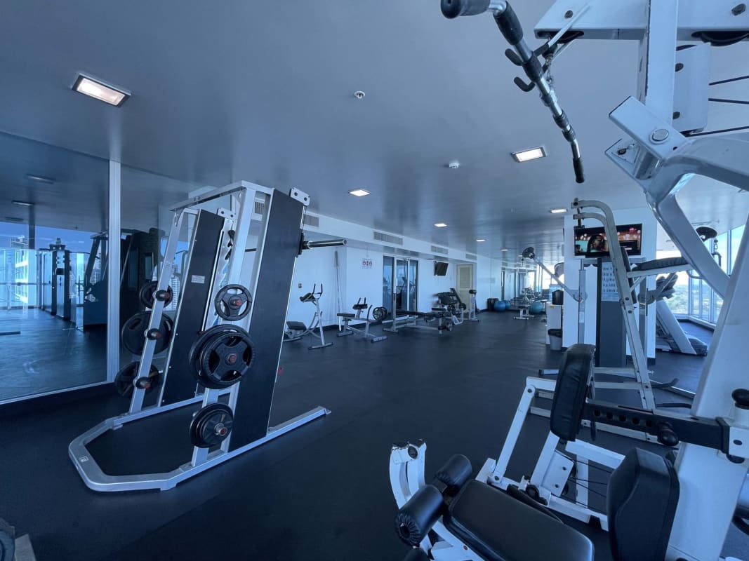 Modern gym with cardio and weights overlooking Panama skyline PH BICSA Avenida Balboa