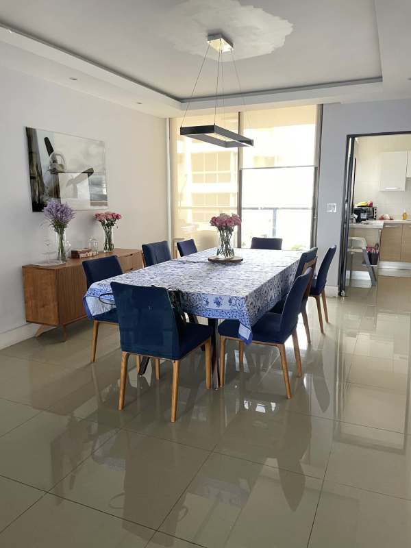 Contemporary dining area with blue chairs and city views in PH San Francisco Bay Panama City