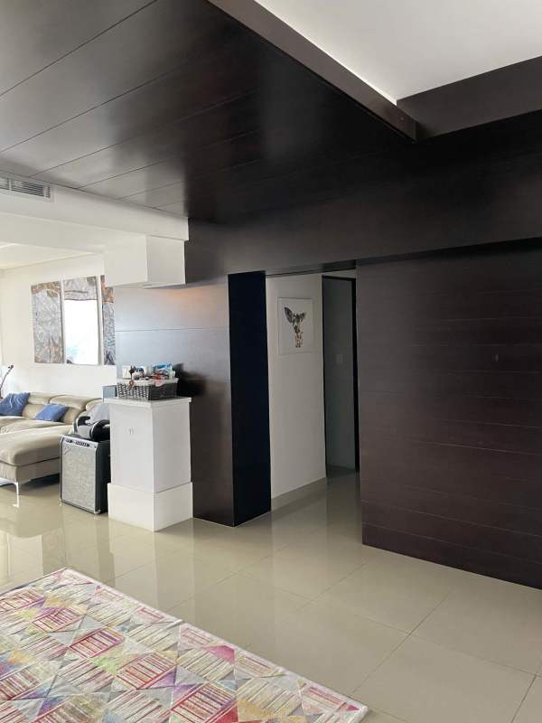 Bright living room with ocean and city views in luxury apartment Panama City