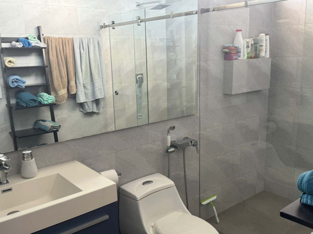 Spacious living room with floor-to-ceiling windows offering panoramic ocean views at PH White Tower Panama City