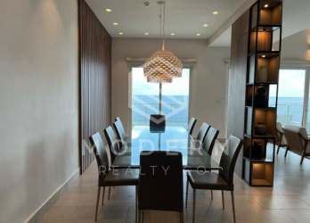 Bright kitchen with quartz counters, white cabinets, breakfast bar and ocean view window at PH Playa Escondida Panama
