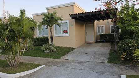 Kitchen with wooden cabinets and black countertop house for rent in PH C-Paradise Coronado Panama