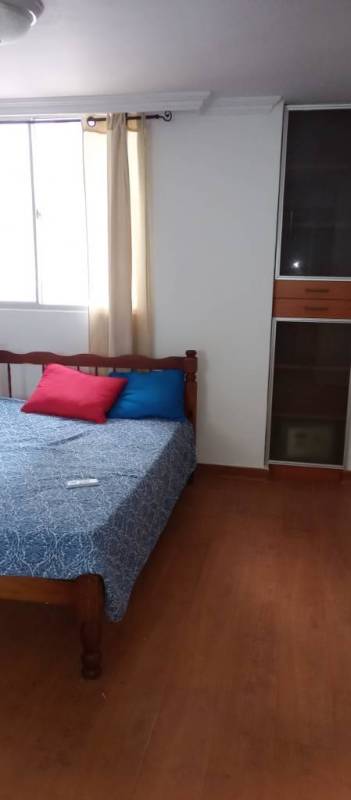 Bedroom with bed colorful cushions built-in wardrobe natural light PH Argentina Tower Chanis Panama