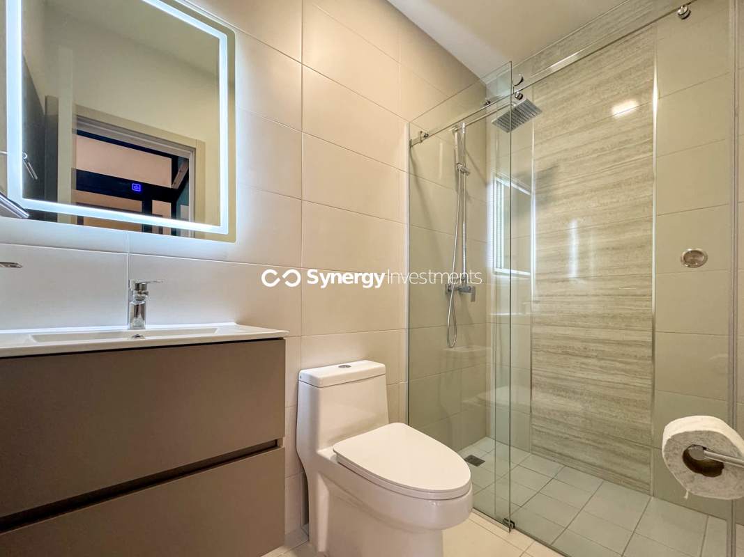 Bright living area featuring floor-to-ceiling windows, glass partitions, and panoramic Panama City skyline views PH Costa del Este Residences