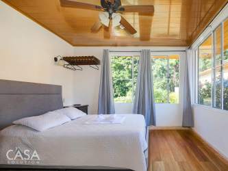 Mountain view backyard with jacuzzi hot tub, hammocks, and green lawns at Hotel Central Boquete Panama