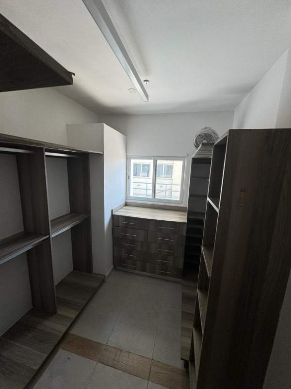 Spacious walk-in closet with built-in shelving and drawers PH Torres de Toscana Panama