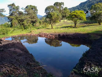 Countryside landscape with private pond, grassy lot and mountain backdrop in Boquete Panama