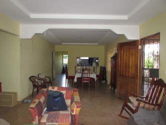 Large open living dining room tiled floors wooden door Burunga Panama