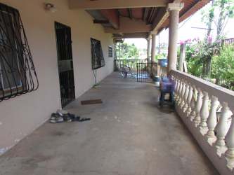 Covered front porch garden fencing family house Burunga Panama