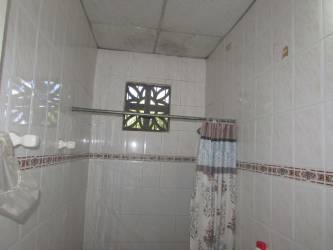 Small bathroom basic fixtures tiled walls shower Burunga Panama