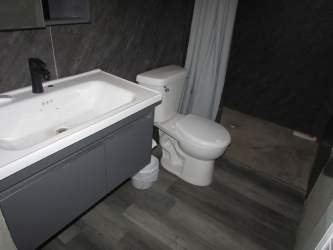 Simple modern bathroom with floating vanity affordable home Arraiján Panama