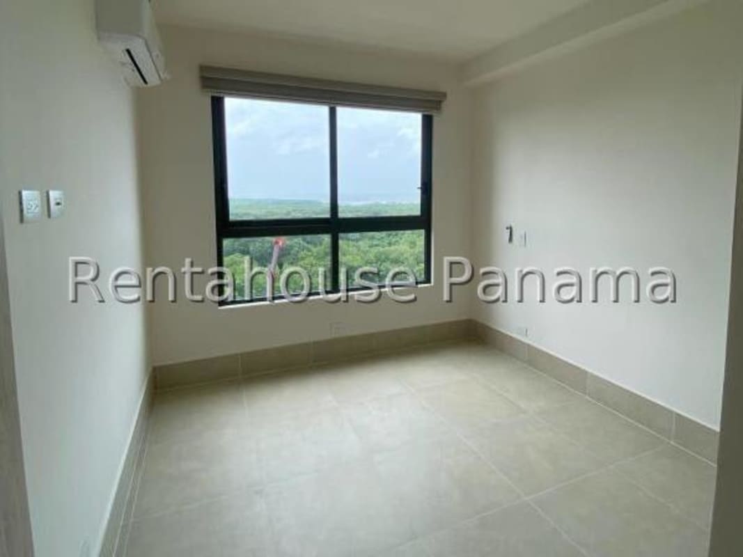 Bedroom in Ocean House with large windows overlooking golf course in Santa Maria Panama