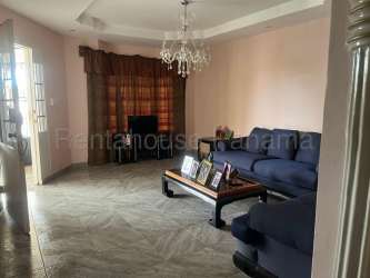 Kitchen with wooden cabinets and ceramic countertops, window and breakfast area Santiago Panama