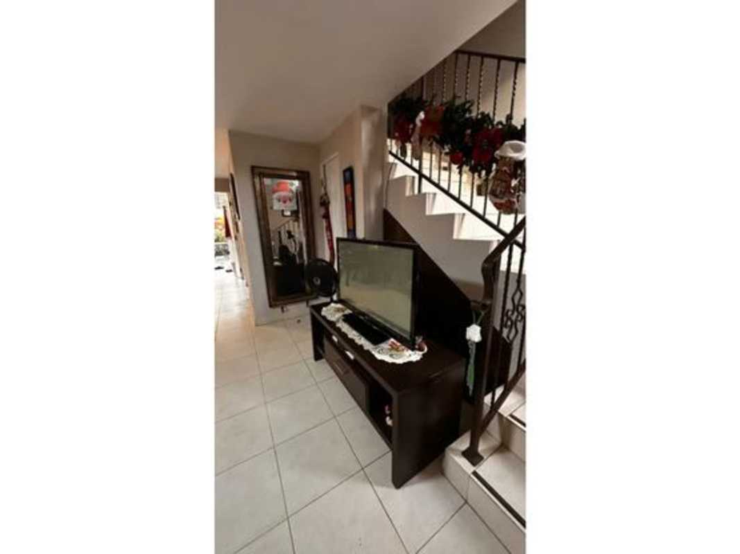 Interior hallway with staircase metal railing tile floor living area Dorado Lakes Panama City