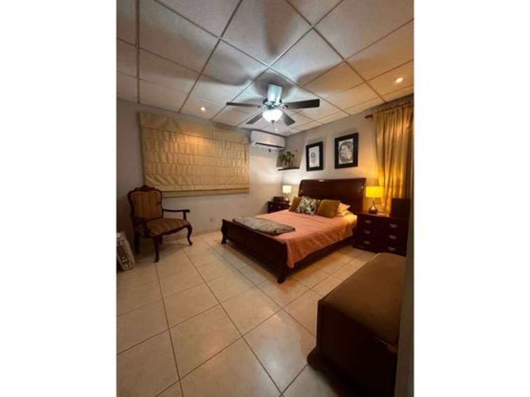 Modern L-shaped kitchen with granite countertops, appliances, tile backsplash in Dorado Lakes Condado del Rey furnished rental