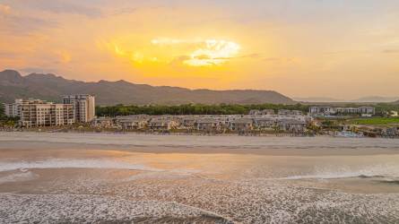 Lagoon style swimming pool, palm trees and beachfront condos at Playa Caracol Punta Chame Panama.