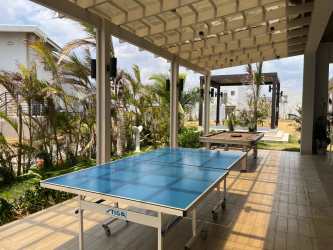 Beachfront buildings with mountain backdrop at sunset Playa Caracol Punta Chame Panama.
