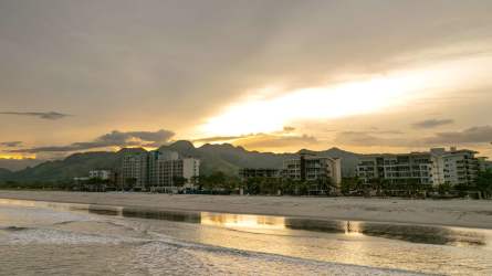Outdoor multi-sport courts with tennis, basketball, mountain backdrop at Playa Caracol Panama.