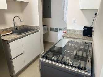 Small kitchen with granite countertops, gas stove space, and cabinetry in Punta Chame condo.