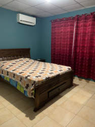 Bedroom with split AC, tiled floor, wooden bed frame Platinium Park Panama