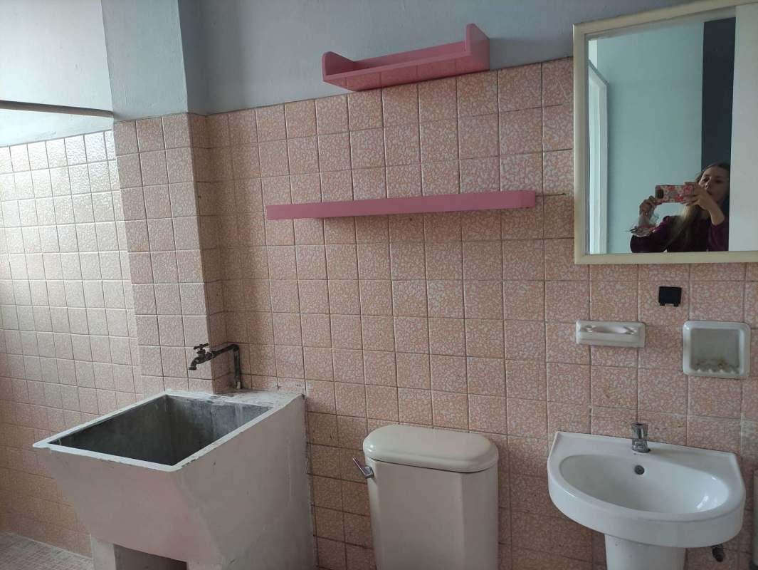 Basic apartment kitchen with tile backsplash, stainless sink at Transístmica Panama City