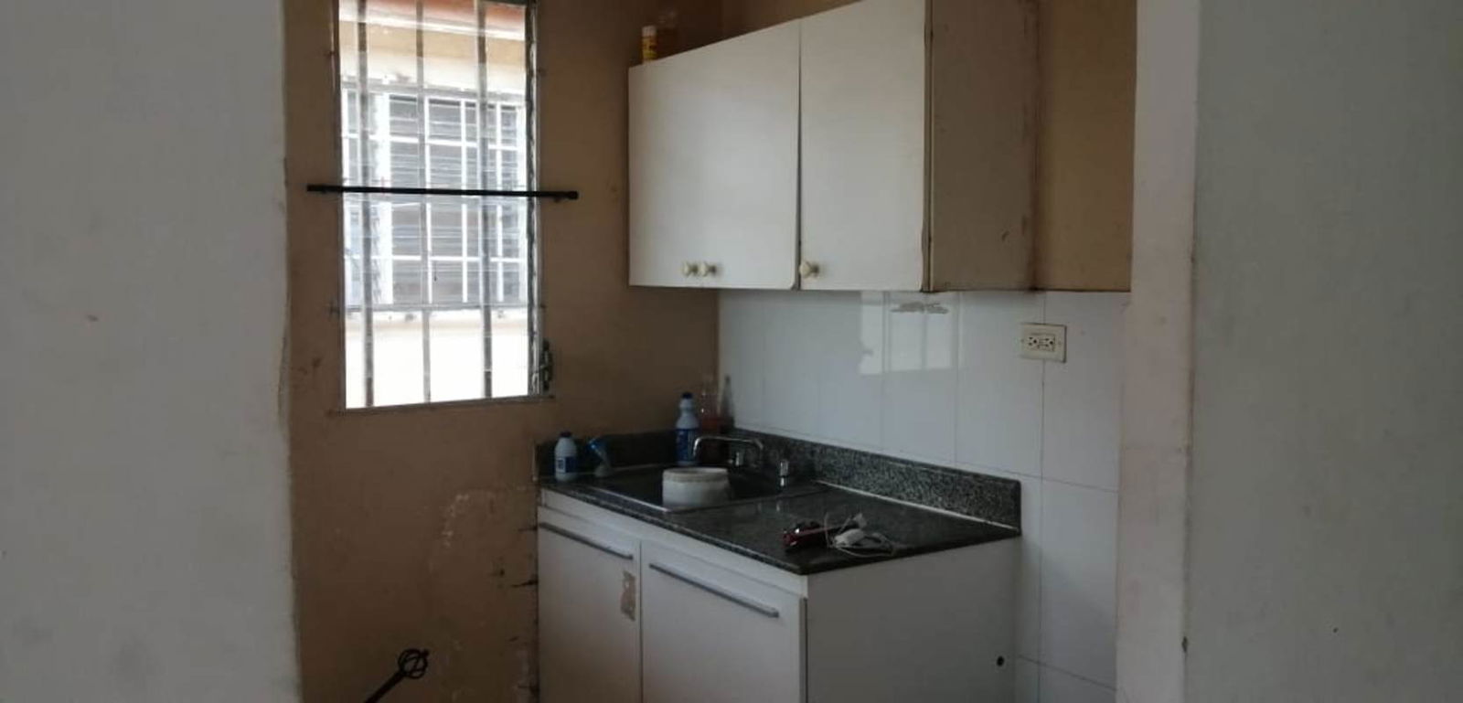 Unfurnished living room with ceramic floors and large window in house for sale Pacora Panama