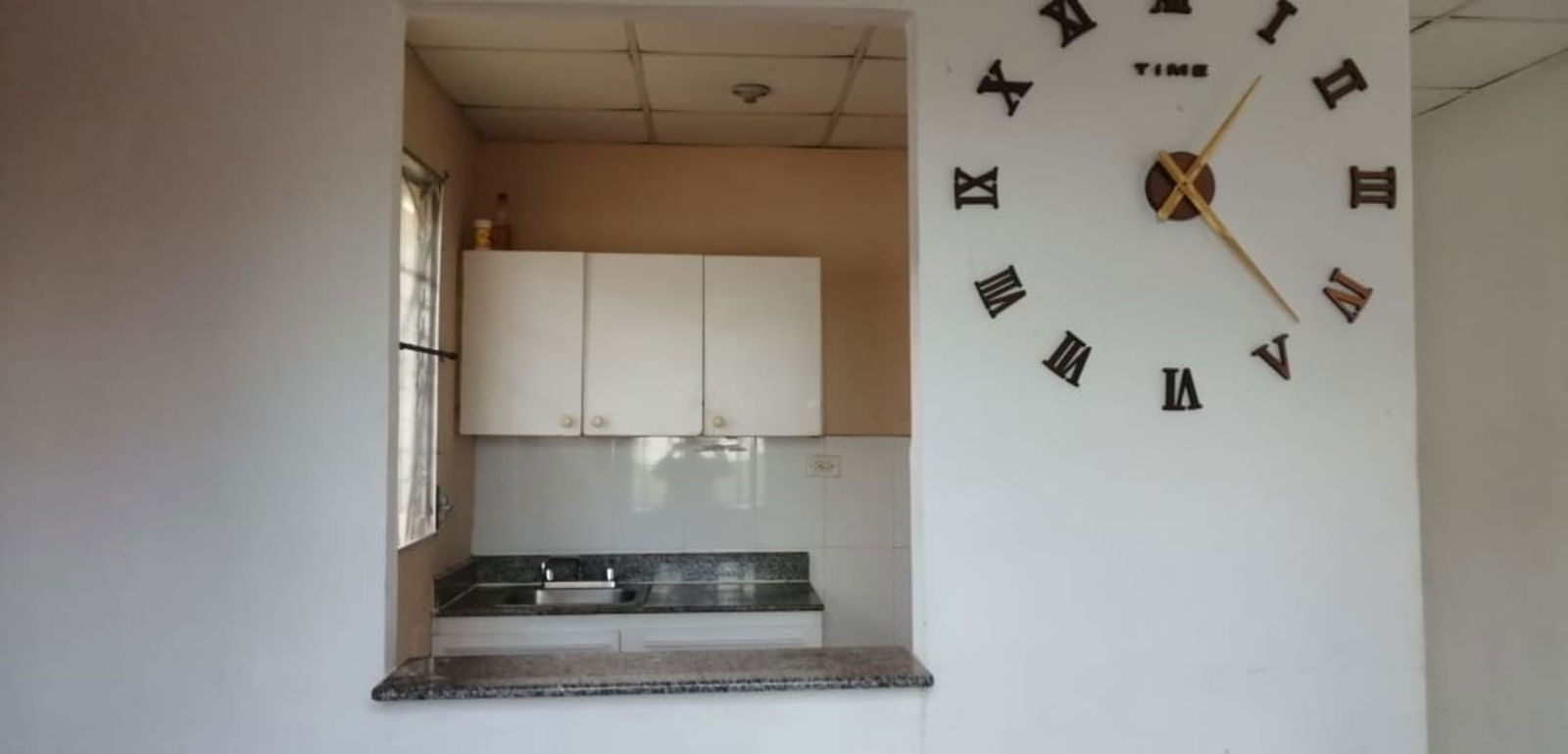 Functional kitchen with granite countertop and breakfast bar in corner lot house Pacora Panama