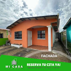 Basic kitchen with peach walls, white cabinets, tiled backsplash in Llano Marín house