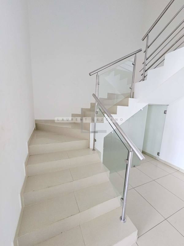 Modern staircase with glass railing in duplex apartment PH Marina Terrace Panama