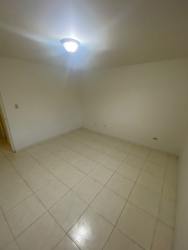 Living room with ceramic tile, neutral colors, and ceiling lighting in duplex Los Cortijos Arraiján