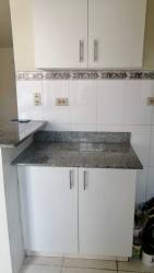 Modern kitchen with white cabinets, granite countertops Arraiján Panama