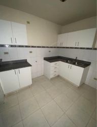 L-shaped kitchen granite counters white cabinets Los Cortijos Panama
