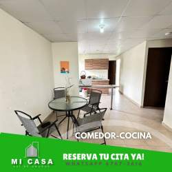 Open plan dining area with glass table and adjacent kitchen in Penonomé house for rent