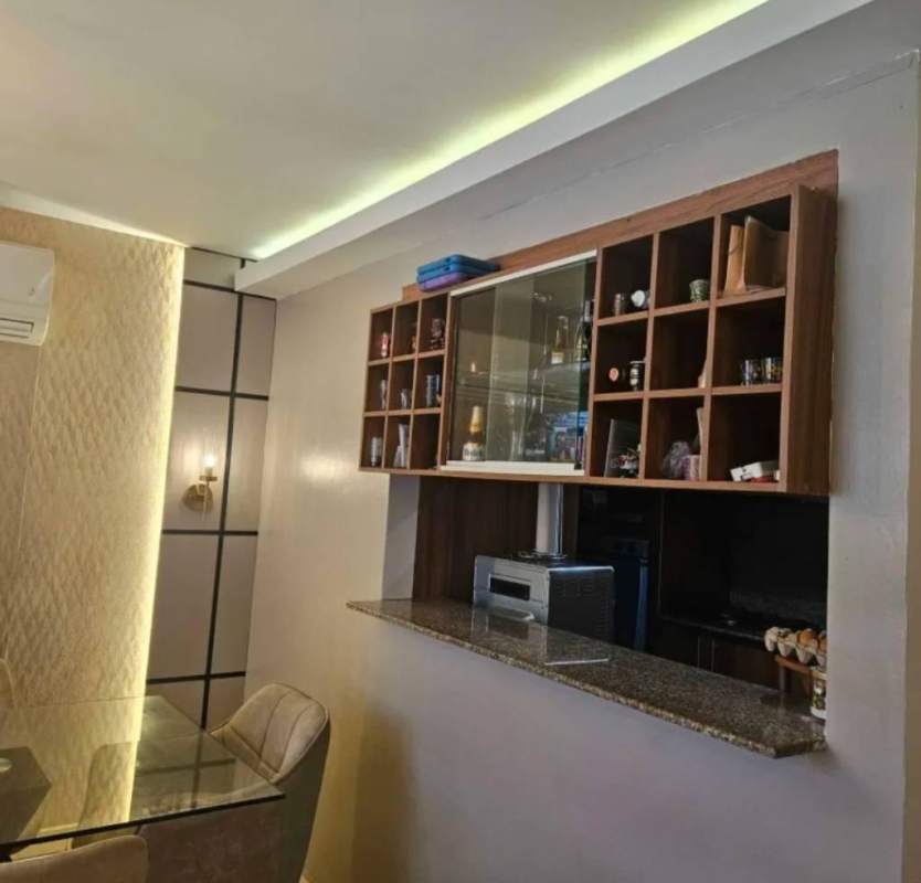 Modern dining space with granite pass-through, shelving, LED lighting and accent wall in Vista del Valle Villa Lucre Panama