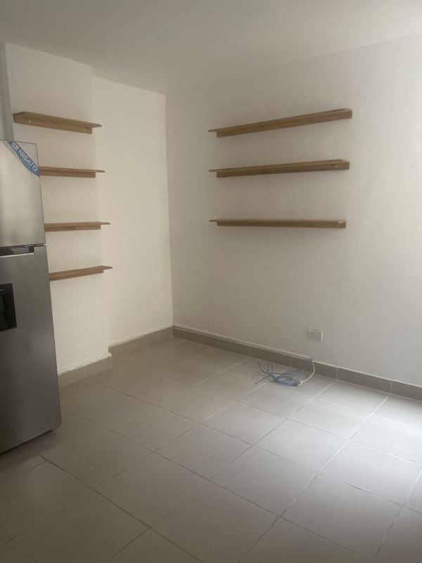 Simple kitchen space with fridge and shelving PH Vistas de Ancón Santa Ana Panama City