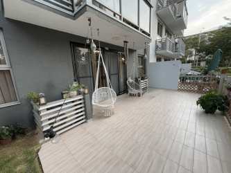 Private terrace with mosaic floor opening to garden PH Parterre Panama Pacifico