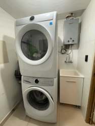 Bright living area with large windows, tiled floor, access to terrace PH Parterre Woodlands Panama Pacifico