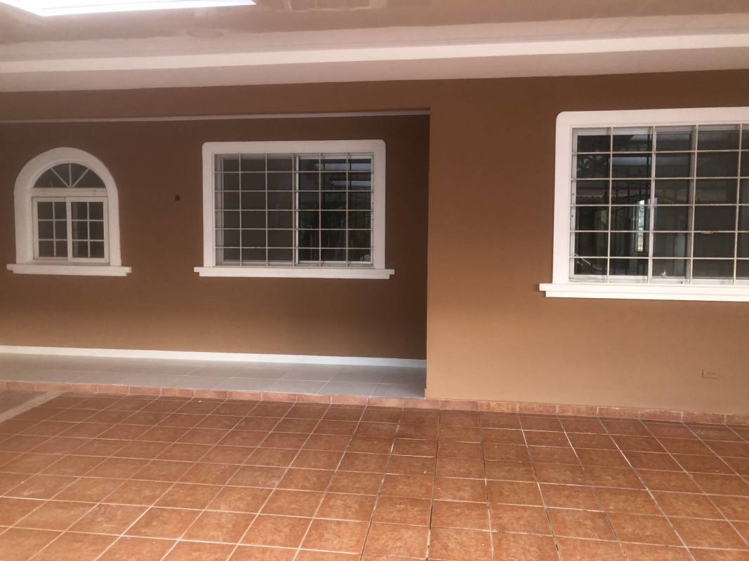 Covered porch with tiled floor and secure barred windows in Quintas de Villa Flor house San Antonio Panama