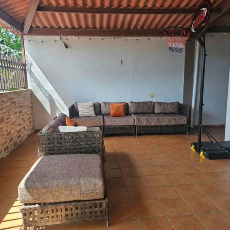 Covered patio with sectional sofa rustic wood roof Villa Lucre Panama