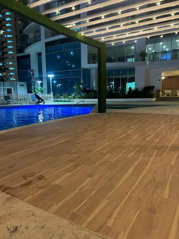 Infinity swimming pool with lounge terrace and city views at PH Pacific Village