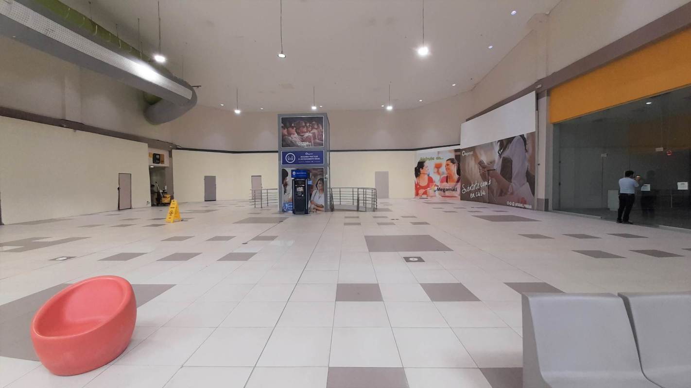 Empty shopping mall corridor with advertising and ATM kiosk inside MegaMall Panama City
