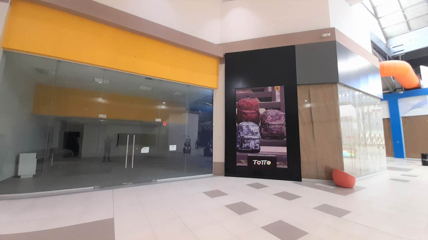 Spacious corridor with storefronts and signage inside MegaMall Panama commercial property
