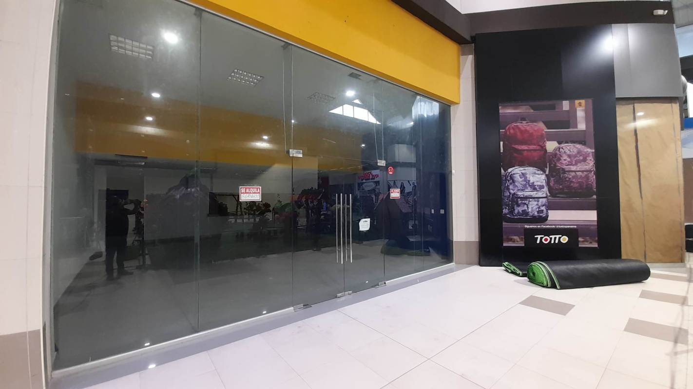 Retail unit with glass doors and signage panel inside MegaMall shopping center Panama City