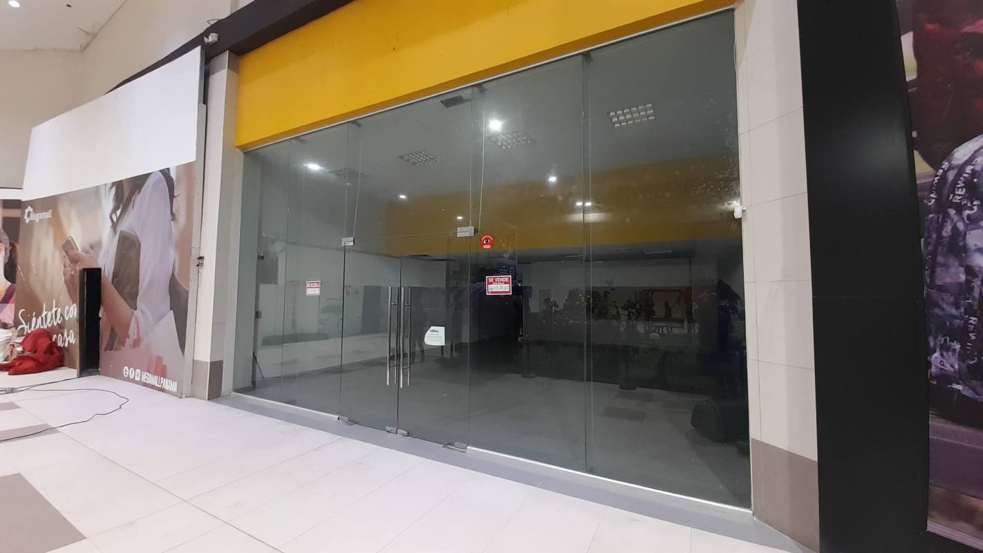 Vacant retail store with large glass entrance and signage inside MegaMall Panama City
